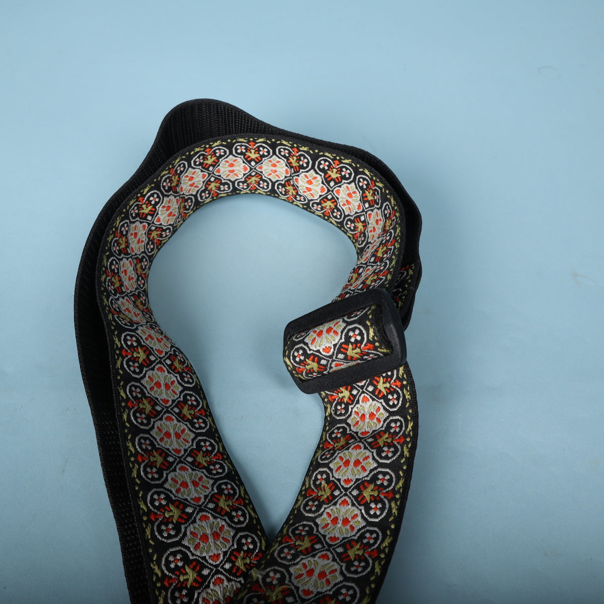 Overhead view of the looped Ernie Ball jacquard strap highlighting the Delrin adjustment buckle