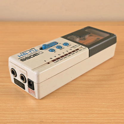 End panel of the Boss TU-12H tuner showing 1/4-inch input, output, and 9V DC adapter jacks.