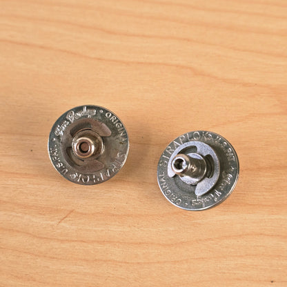 Another overhead view highlighting the stamped text and circular design of the Jim Dunlop strap locks.