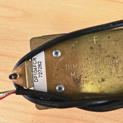 Close-up of baseplate sticker showing DP104FCR model designation and serial number
