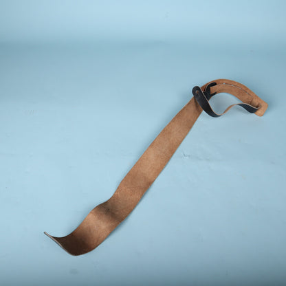 Full length view showing the suede backing and adjustment tail of the strap