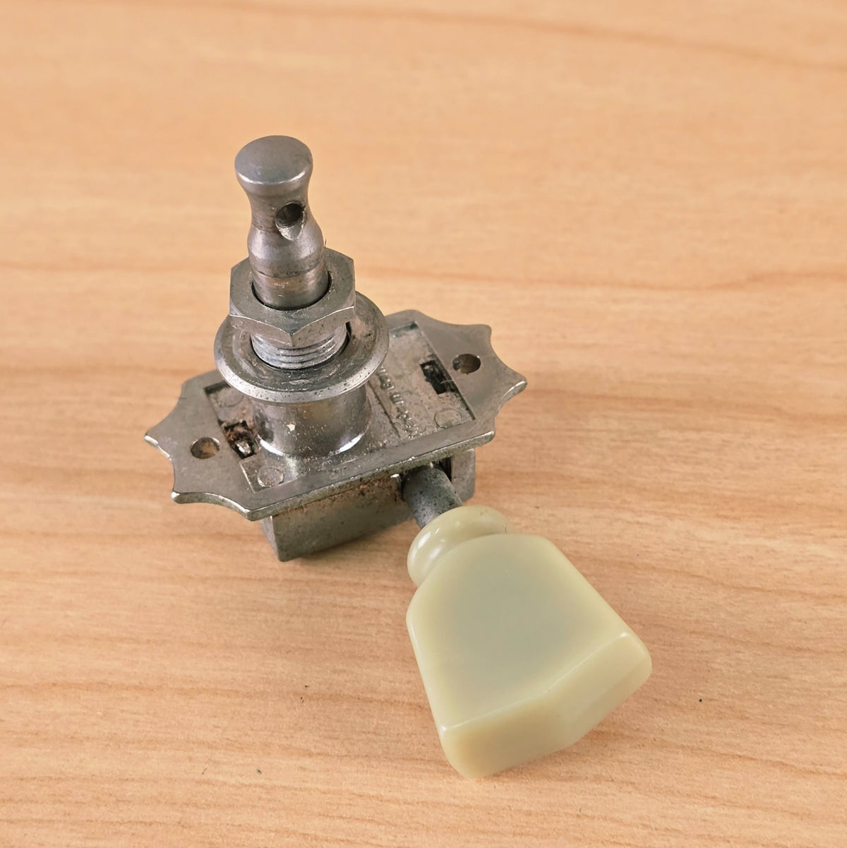 Overhead view of the tuner showing post, washer, collar nut, and tulip button.