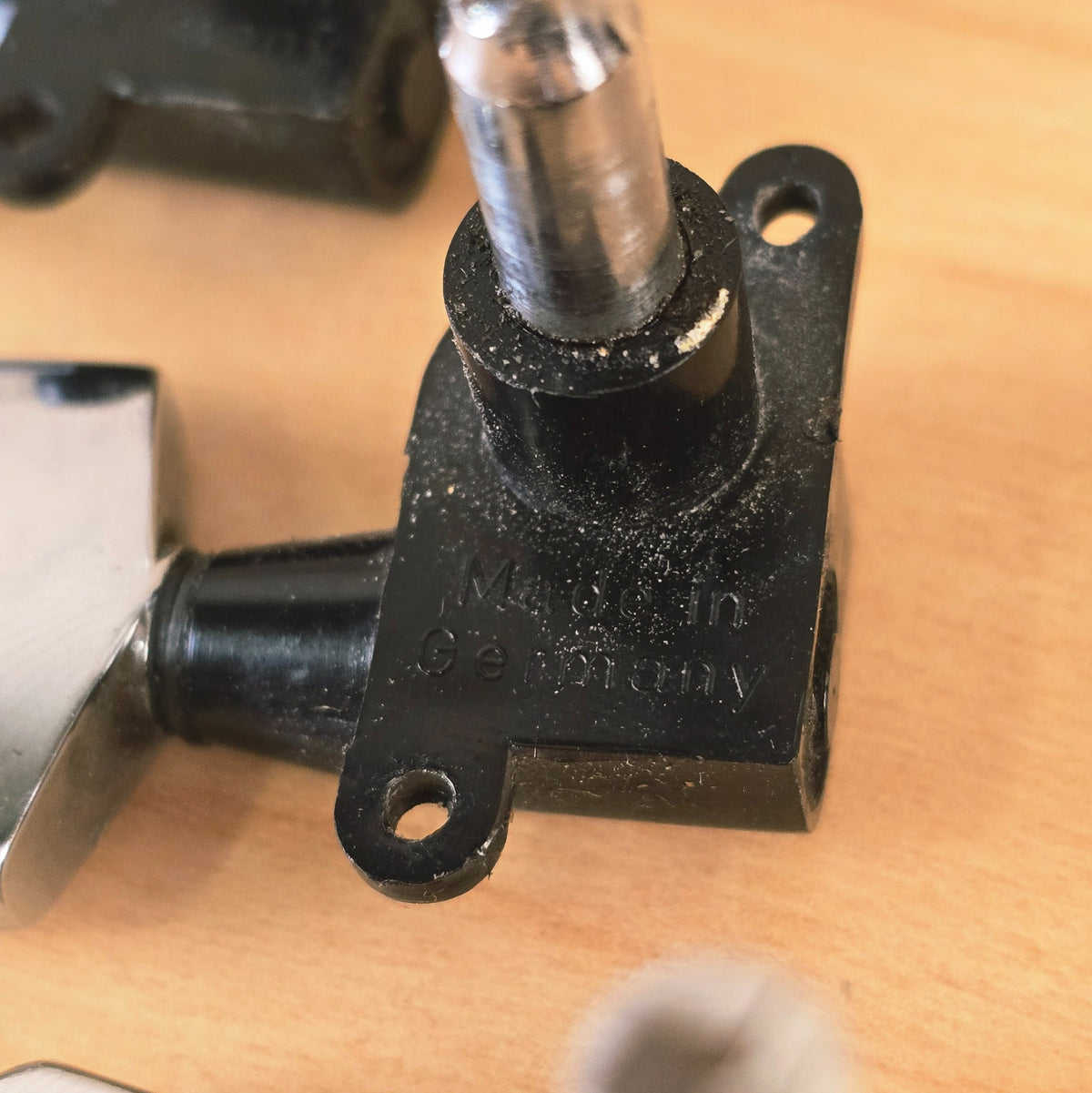 Detailed angle of Made in Germany text on tuning machine baseplate
