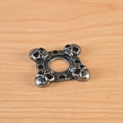 Angle view of cast metal skull motif guitar part
