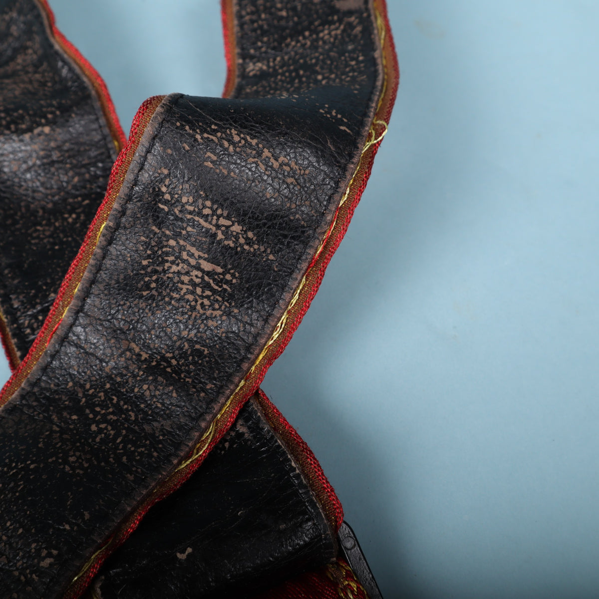 Detailed view of surface flaking and cracking on the black strap lining