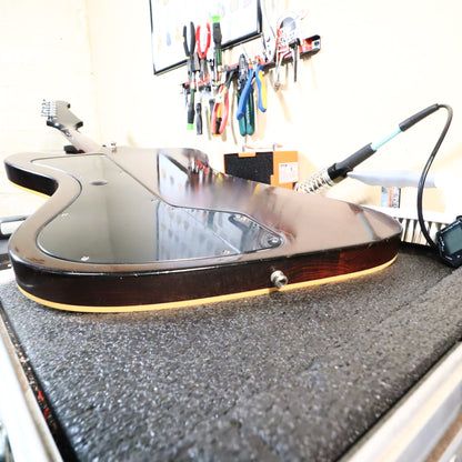 Rear side angle of the body resting on a workbench showing edge contours.