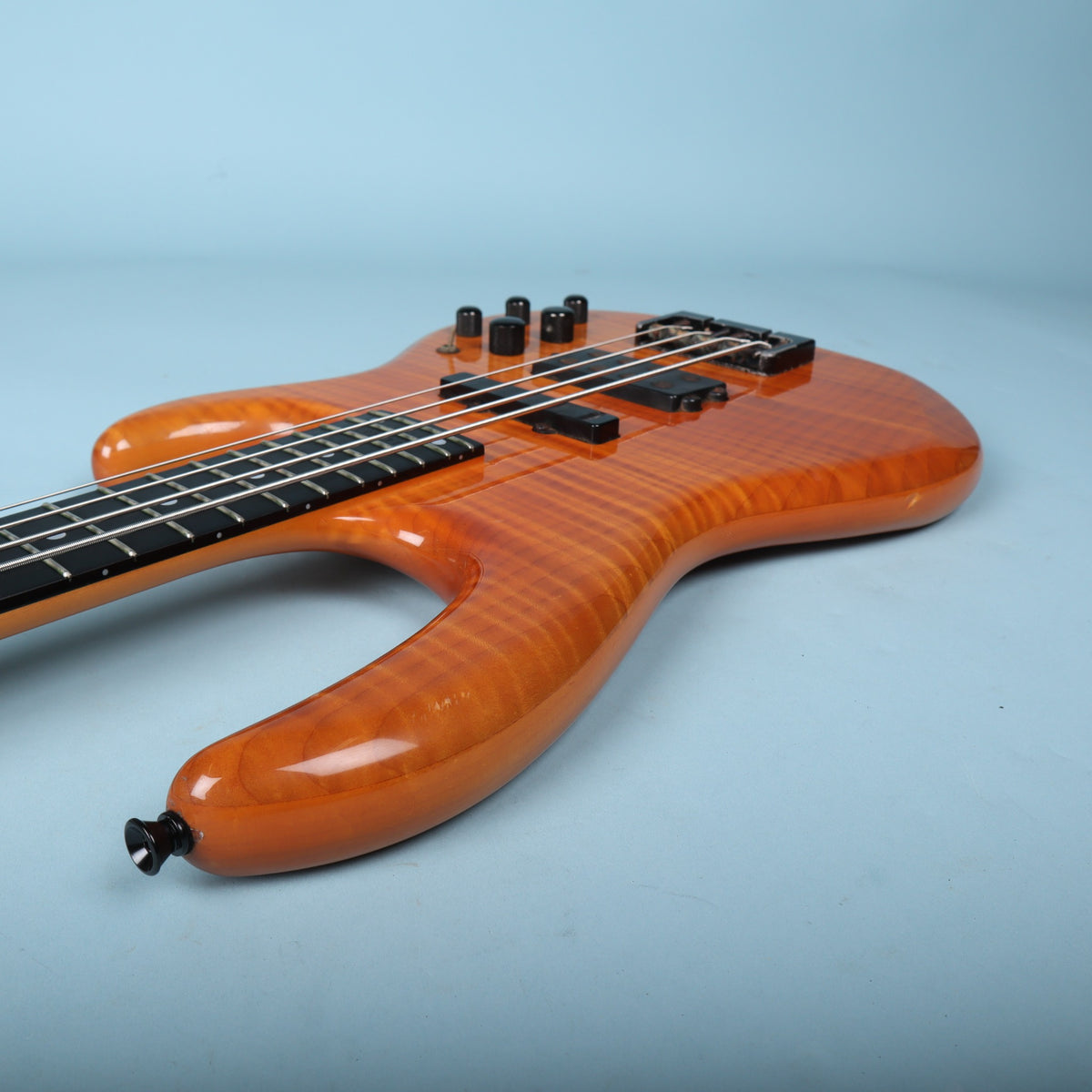 Close-up of the sculpted upper horn showing the deep tiger-stripe maple grain.