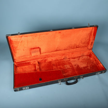 Open empty vintage Fender hardshell case with orange plush interior