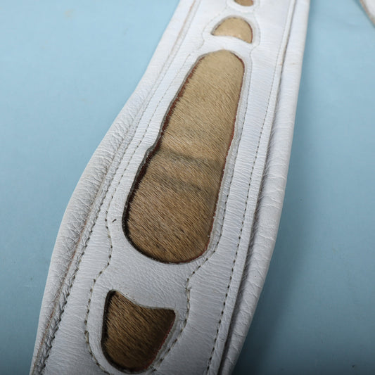 Close-up detail of the front stitching and soft tan faux fur cutouts.