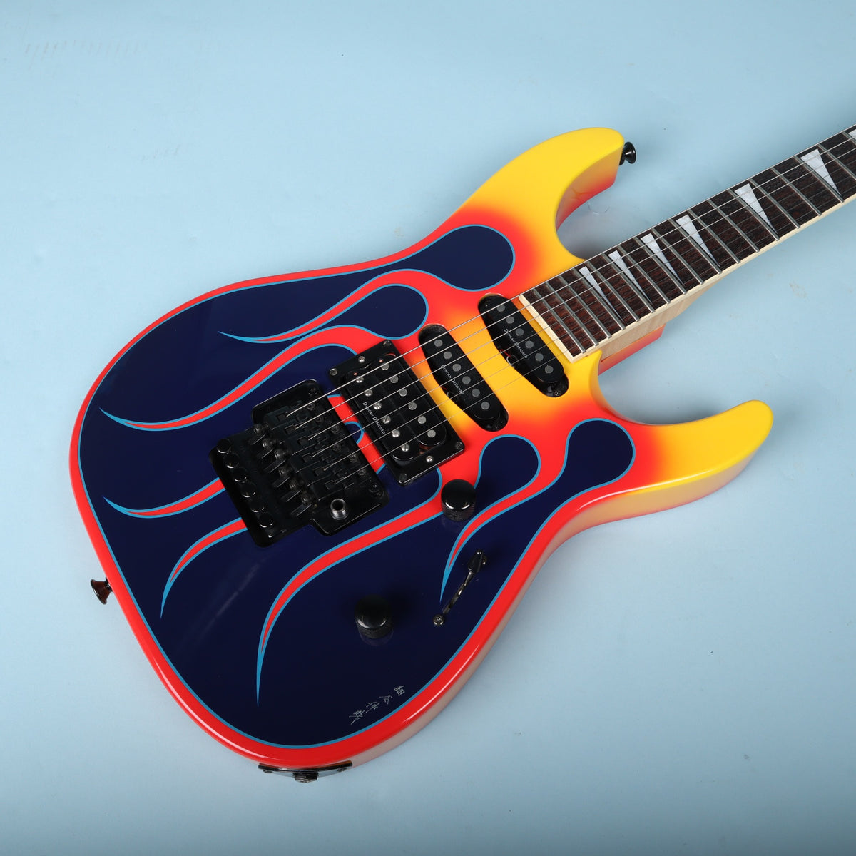 Angled front body view highlighting flame graphic and control knobs