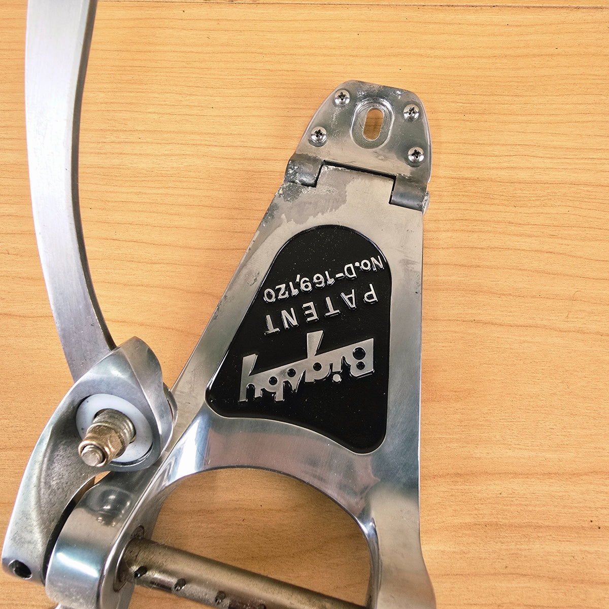 Angled view showing the hinge connection and Bigsby patent plate.