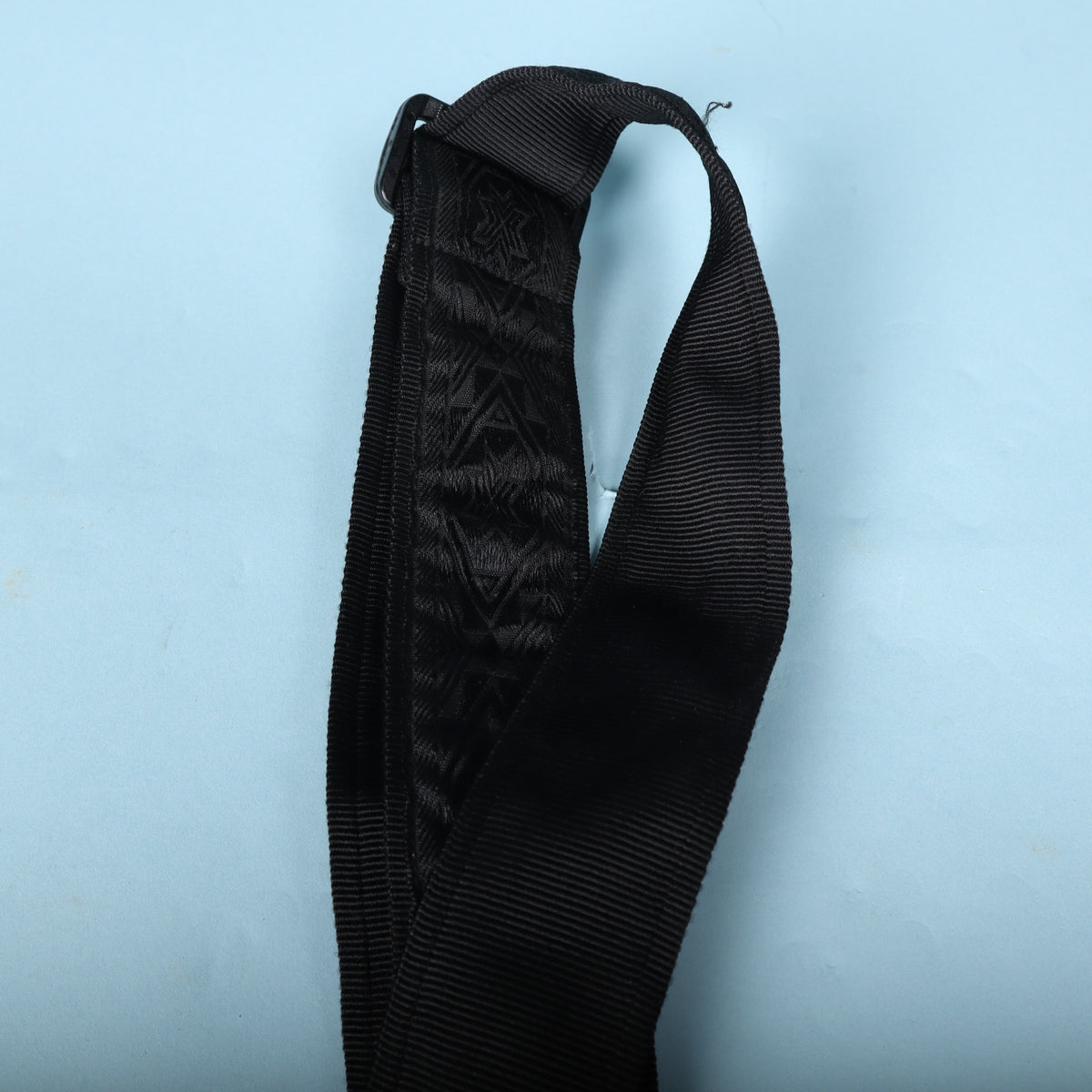 Close-up of the adjustment loop and black plastic hardware buckle.