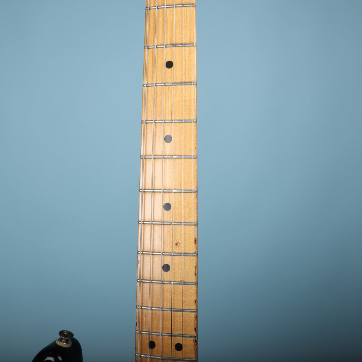 Close-up of the maple fretboard and neck frets