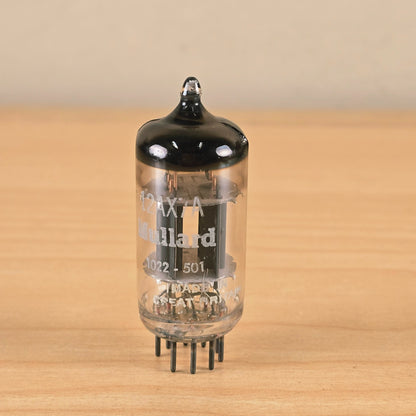 Straight-on view of Mullard 12AX7A vacuum tube standing upright.