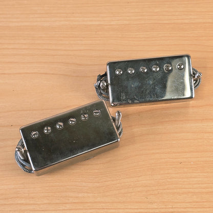 Top view of two nickel Lollar Imperial humbucker pickups with mounting screws.