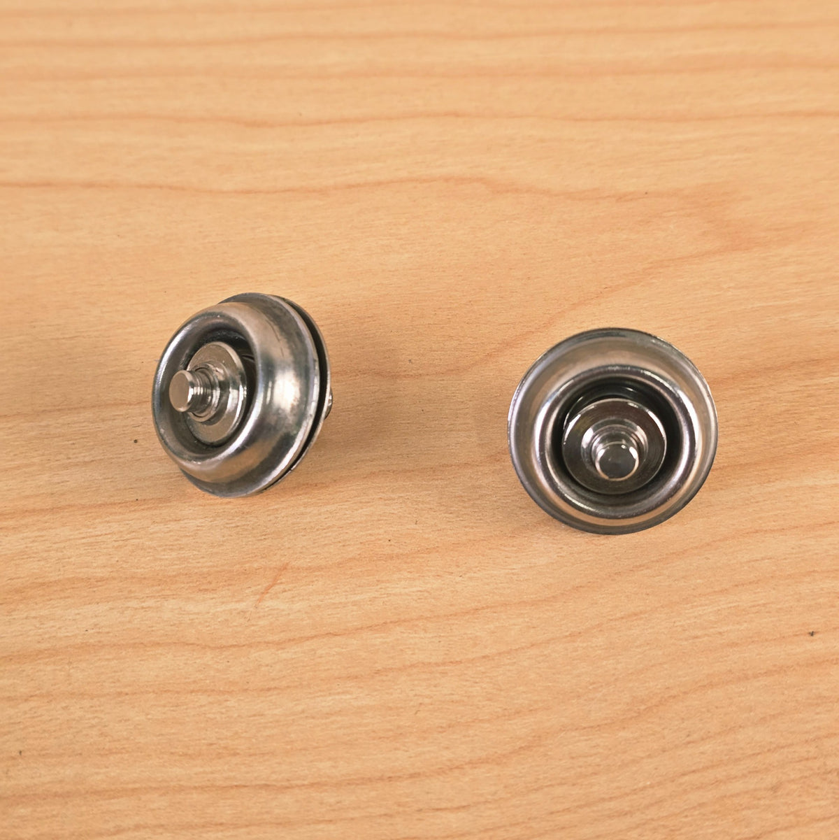 Side and bottom view showing the quick-release plunge mechanism of the Jim Dunlop strap locks.