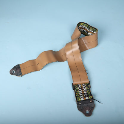 Full rear view of the strap laid out flat showcasing the complete tan vinyl backing.