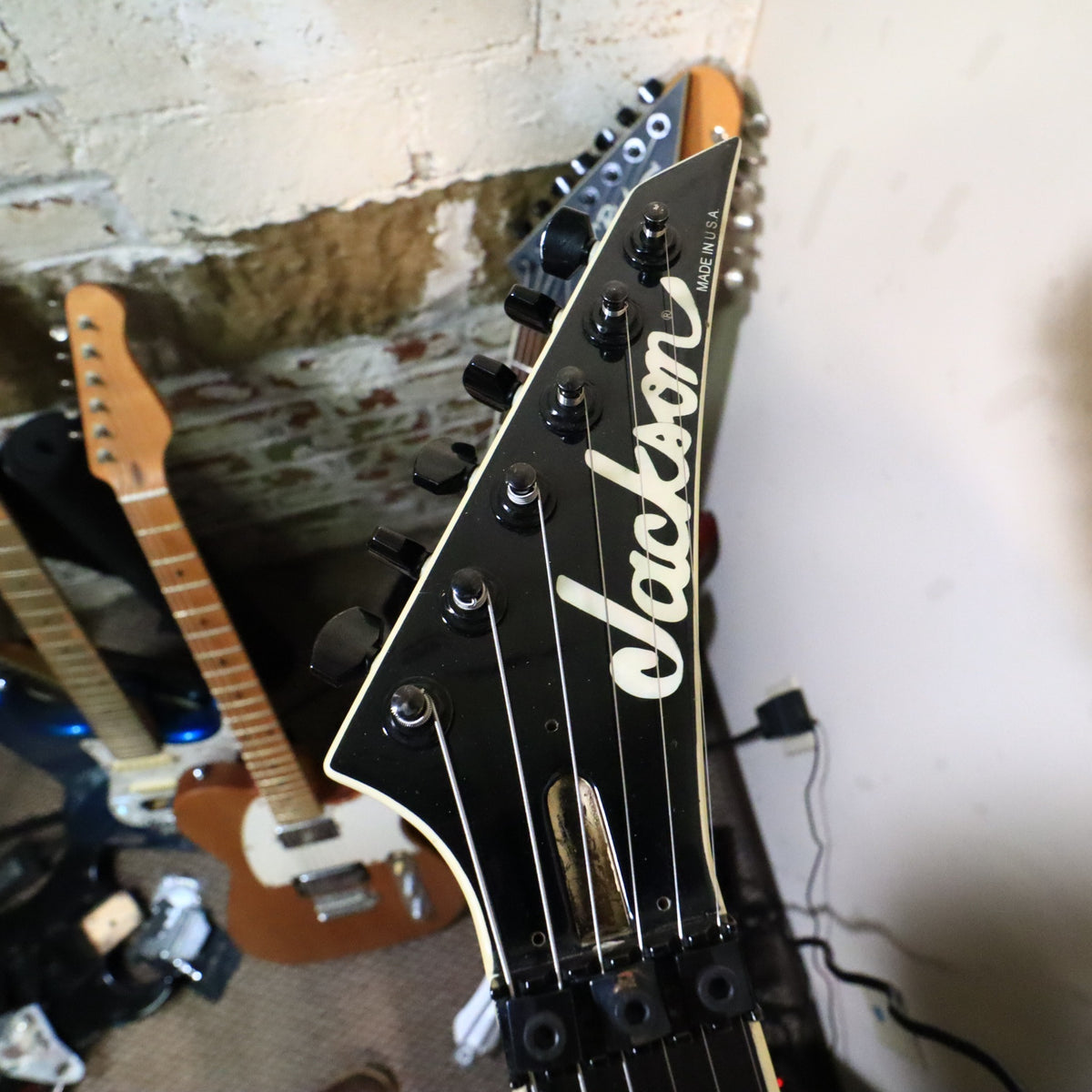 Front view of the pointed Jackson headstock showing the pearl logo and Made in U.S.A. text