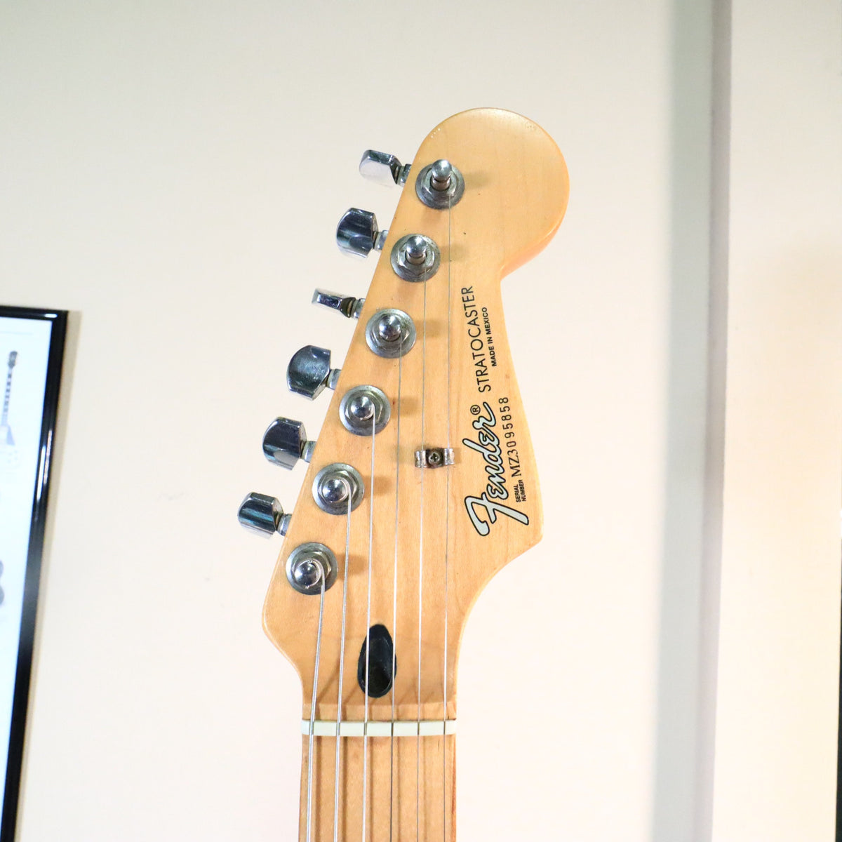 Front of headstock showing Fender Stratocaster logo and serial number MZ3095858