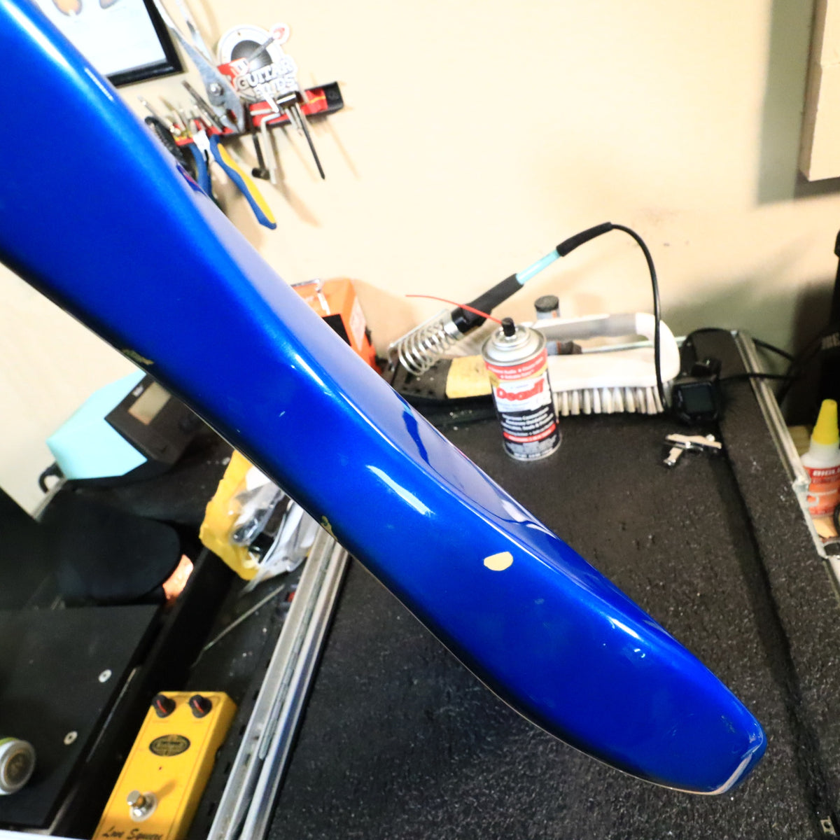 Close-up showing paint wear and a chip on the body edge