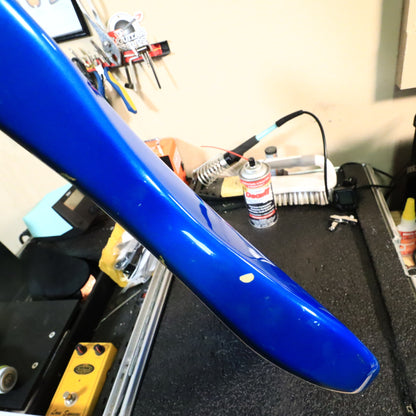 Close-up showing paint wear and a chip on the body edge