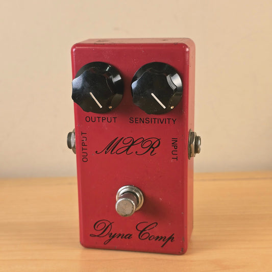 Front full view of a vintage 1970s MXR Dyna Comp script logo compressor pedal in red finish.
