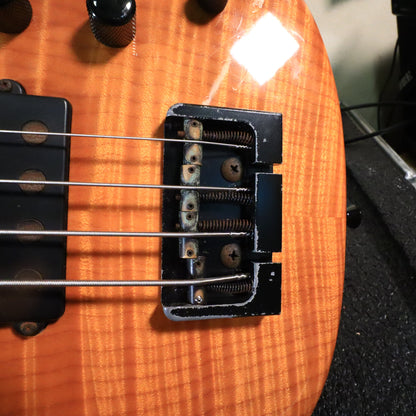 Close-up of the black high-mass bridge showing finish wear and saddle springs.