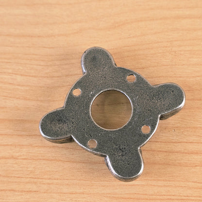 Underside view showing four mounting holes of the metal part