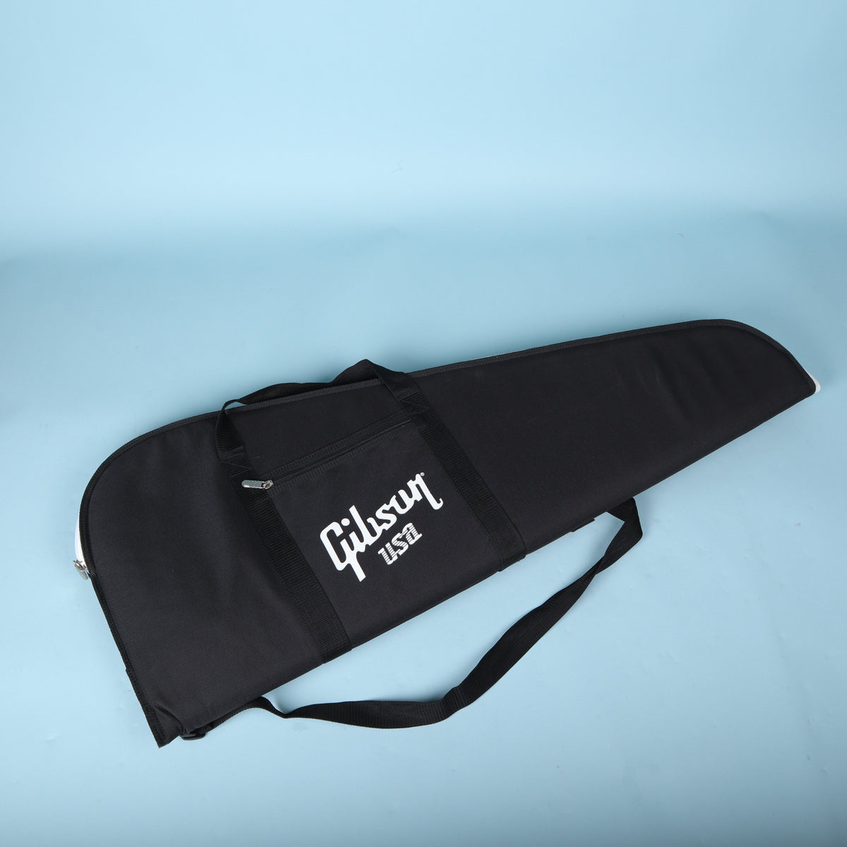 Angled top-down view of a black Gibson USA electric guitar gig bag with white logo.