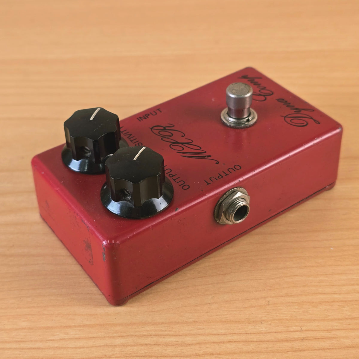 Angled side view focusing on the left output jack and enclosure edge of the MXR Dyna Comp.