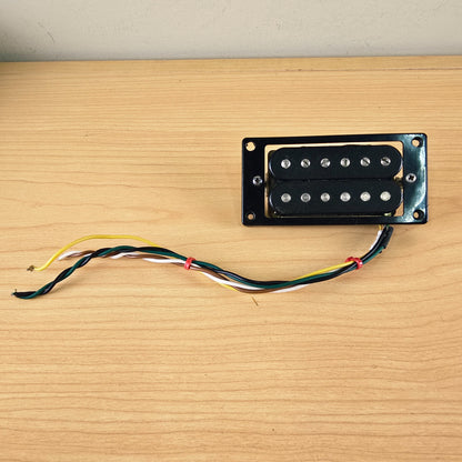 Direct top view of the Schaller humbucker pickup in its black mounting ring