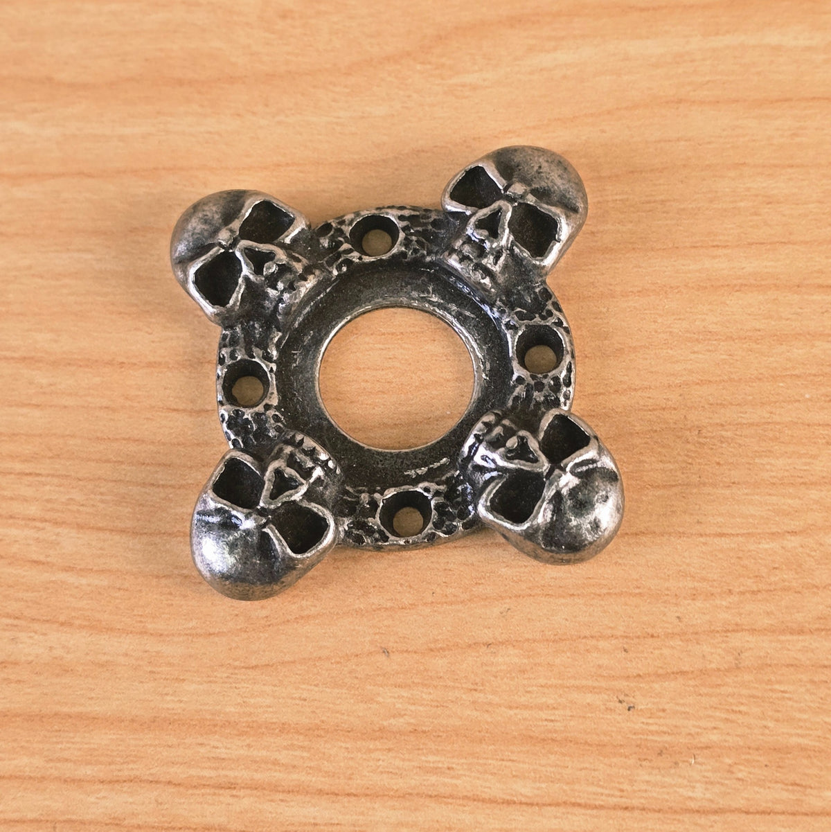 Detailed view of skull embellishments on metal part