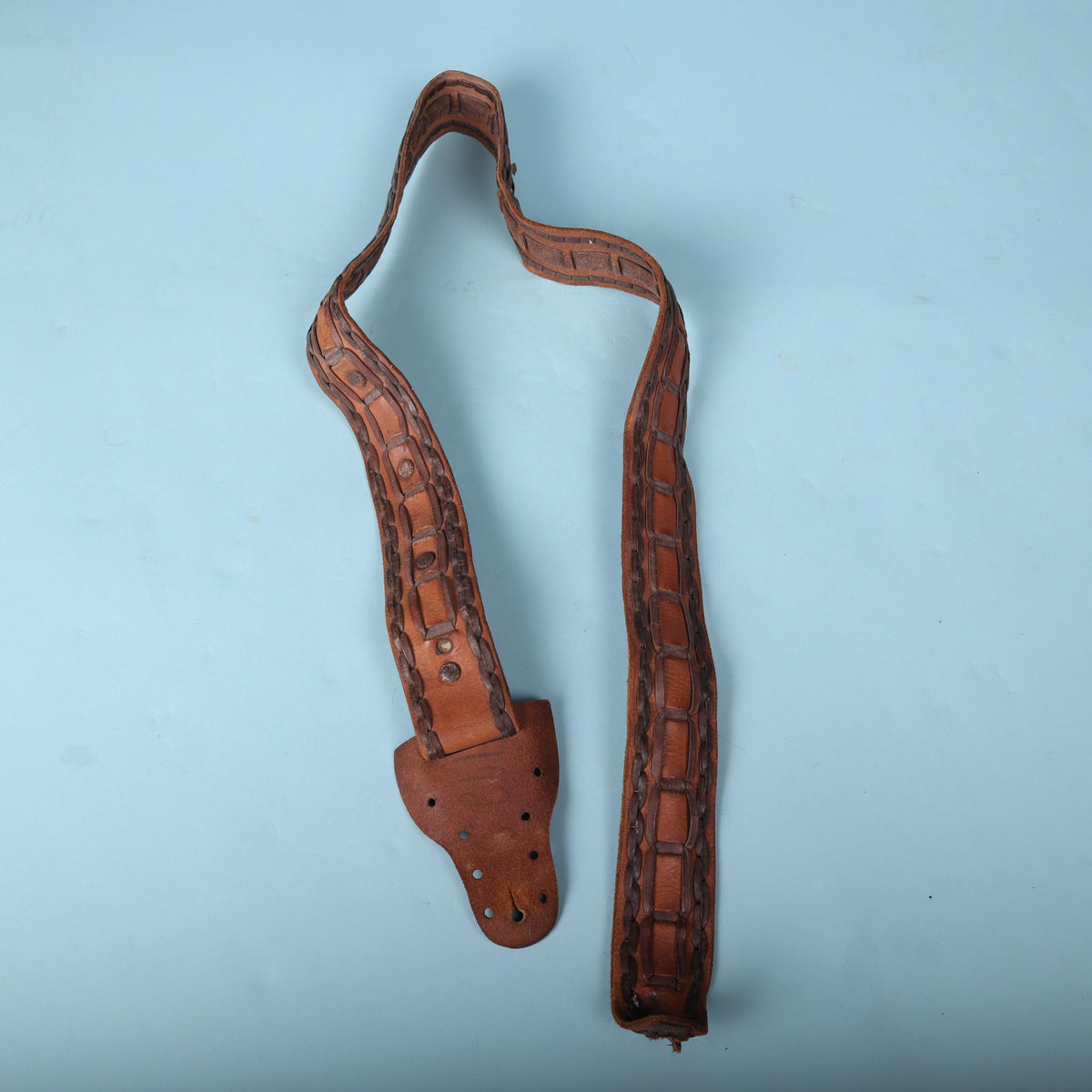 Full layout of vintage handmade Mexican leather guitar strap
