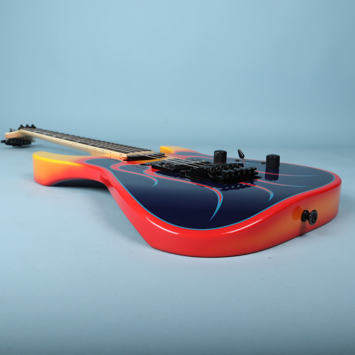 Bottom edge profile displaying red and yellow edge finish and strap button