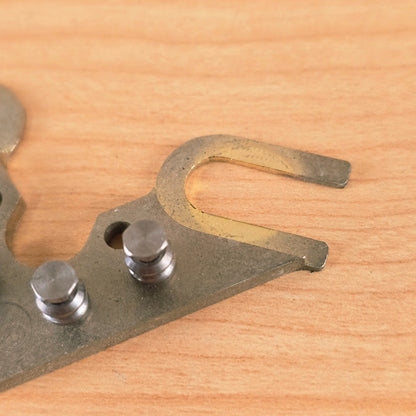 Close-up of open tuner mounting fork displaying plating patina and wear