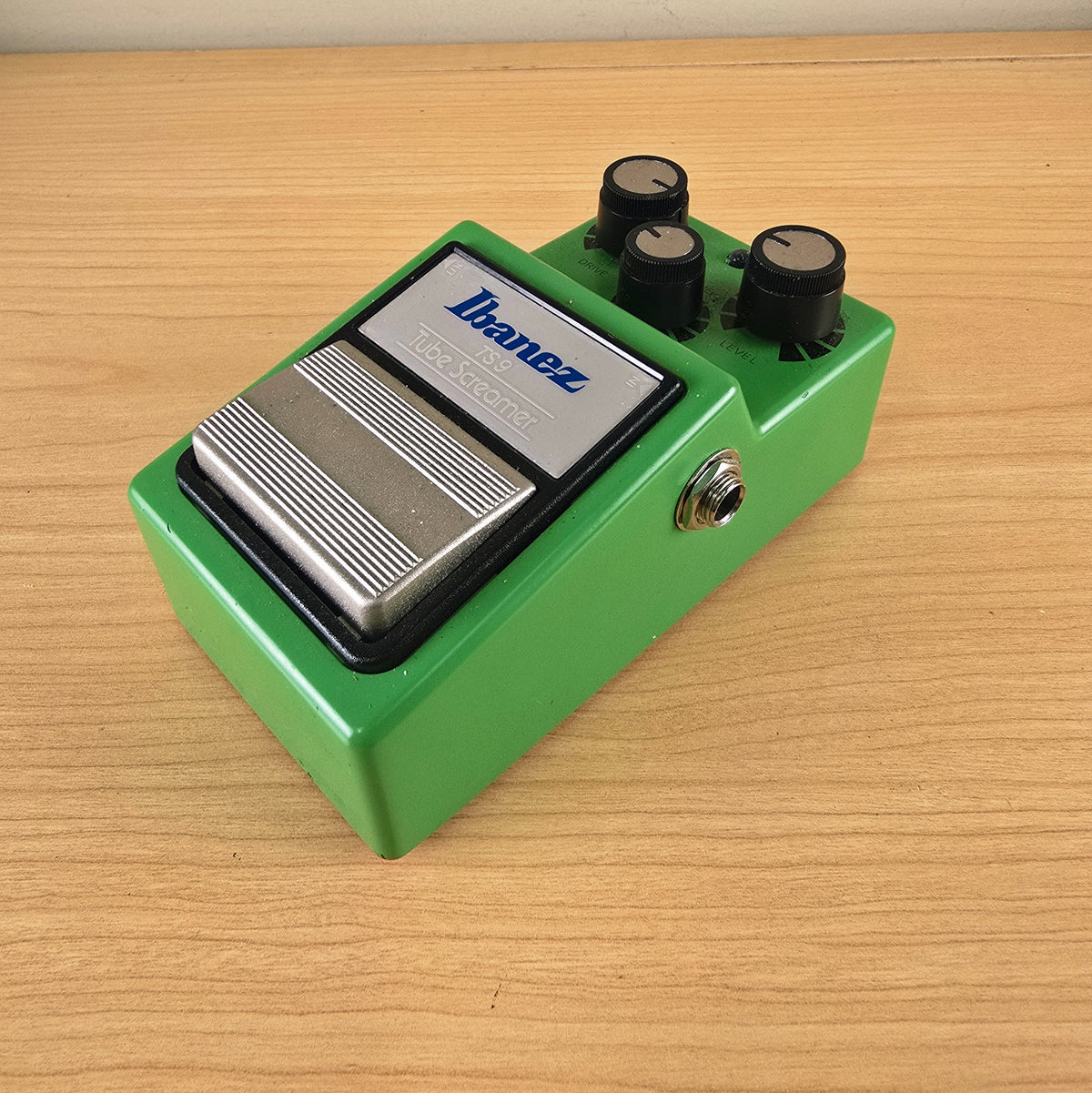 Angled high-angle view of the front and right side of an Ibanez TS9 Tube Screamer overdrive pedal.