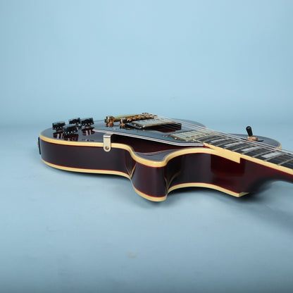 Front headstock close-up of Epiphone Les Paul Custom on setup bench