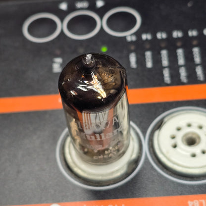 Top-down view of Mullard 12AX7A tube seated in tube tester socket.