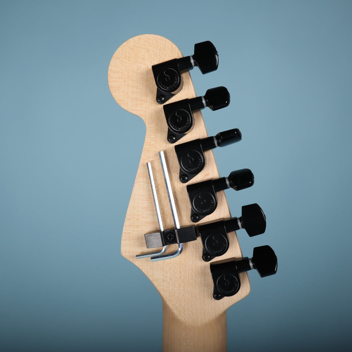 Back of headstock showing black Schaller tuning machines and mounted hex wrenches.