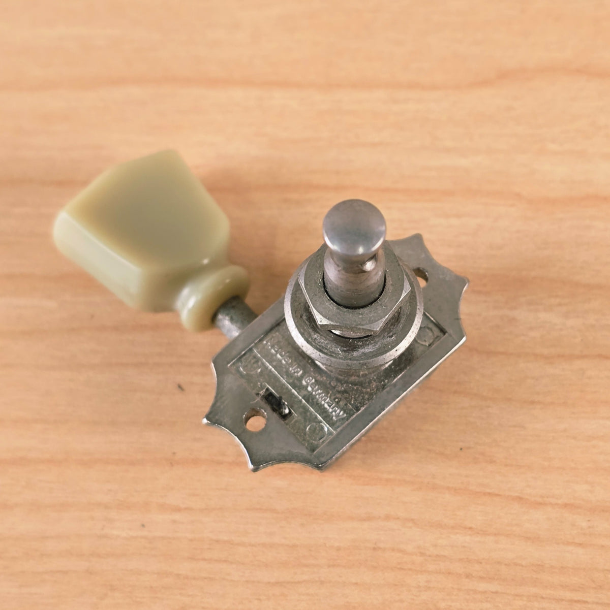Underside view of tuner mounting plate showing Made in Germany stamp and hex nut collar.