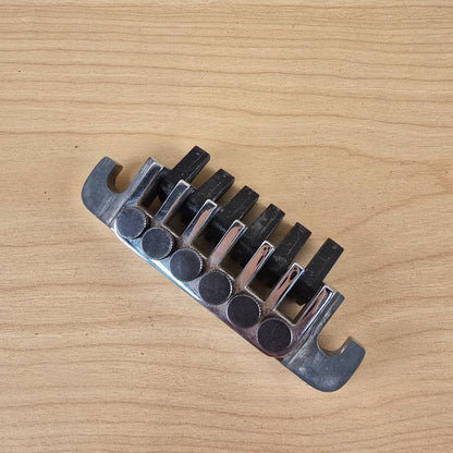 Top view showing string receiver slots and black tuning claw blocks