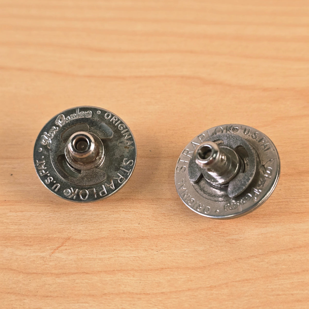 Slightly angled overhead view of the two Jim Dunlop Original Straplok metal mechanisms.