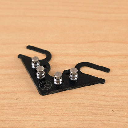 Top-down angled view of a black Dietrich Parts String Butler V3 on a light wood surface