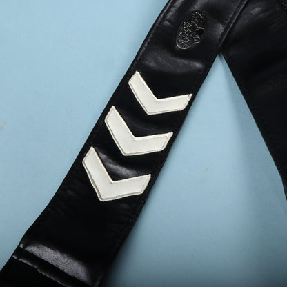 Detailed view of three white stitched chevron stripes on the black leather strap