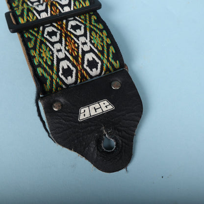 Close-up of the black leather end tab featuring the embossed white 1970s Ace logo.