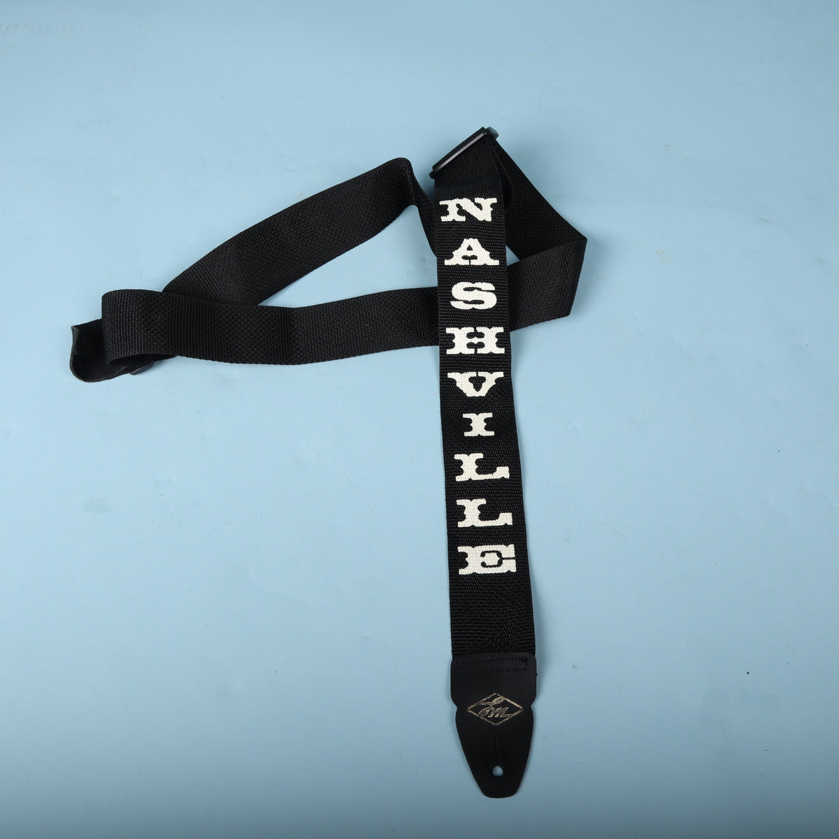 Angled view of the black LM Products Nashville guitar strap highlighting the adjustment buckle