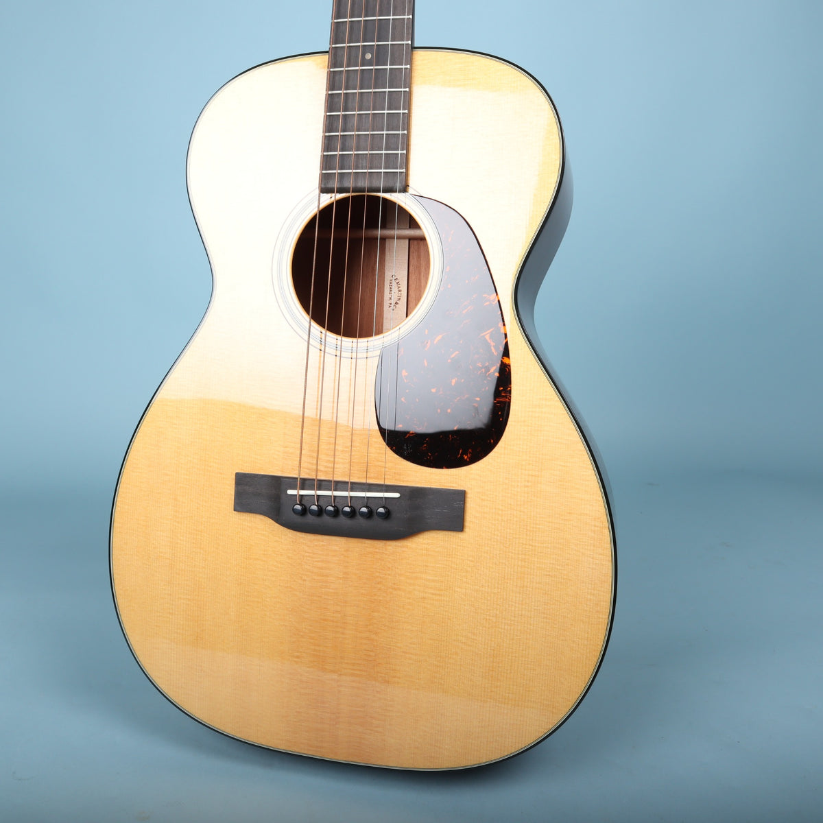 Front view of the Martin 0-18 body showing the spruce top, soundhole, bridge, and tortoise pickguard.