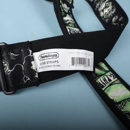 Close-up of the manufacturer tag displaying Dunlop Guitar Straps D3816DI L13 DEAD ISLAND and barcode.
