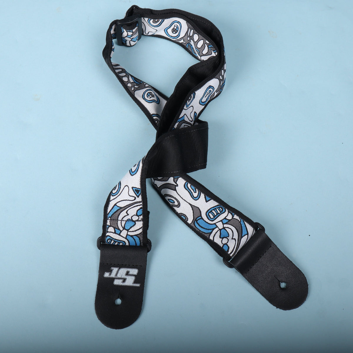 Rear angled view of the guitar strap showing the black backing and plastic adjustment hardware
