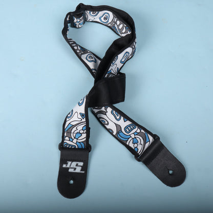 Rear angled view of the guitar strap showing the black backing and plastic adjustment hardware